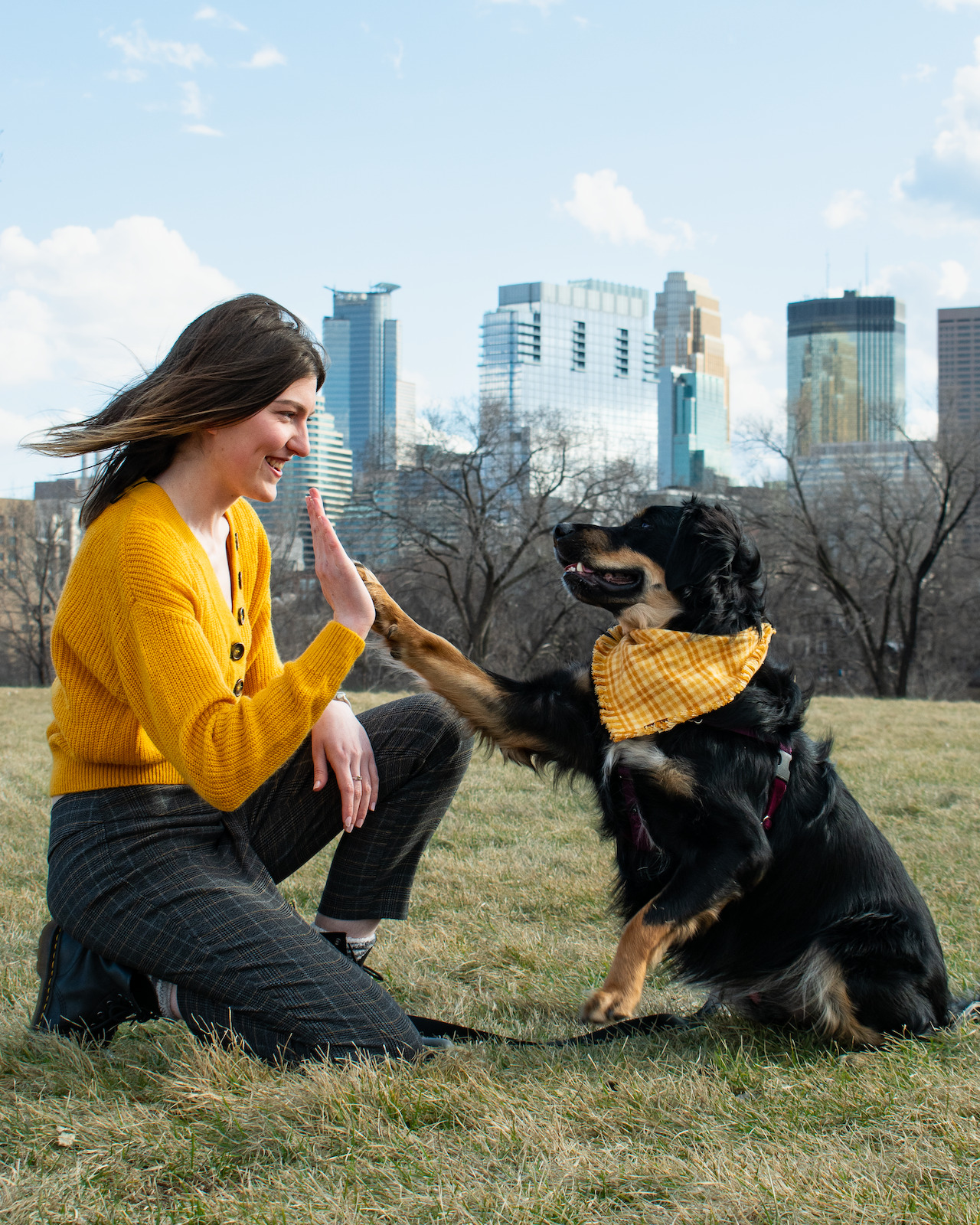 Bethany the Metro Dogs head Trainer with Pete her Aussie/Hound Mix with the Minneapolis City Skyline in the Background
