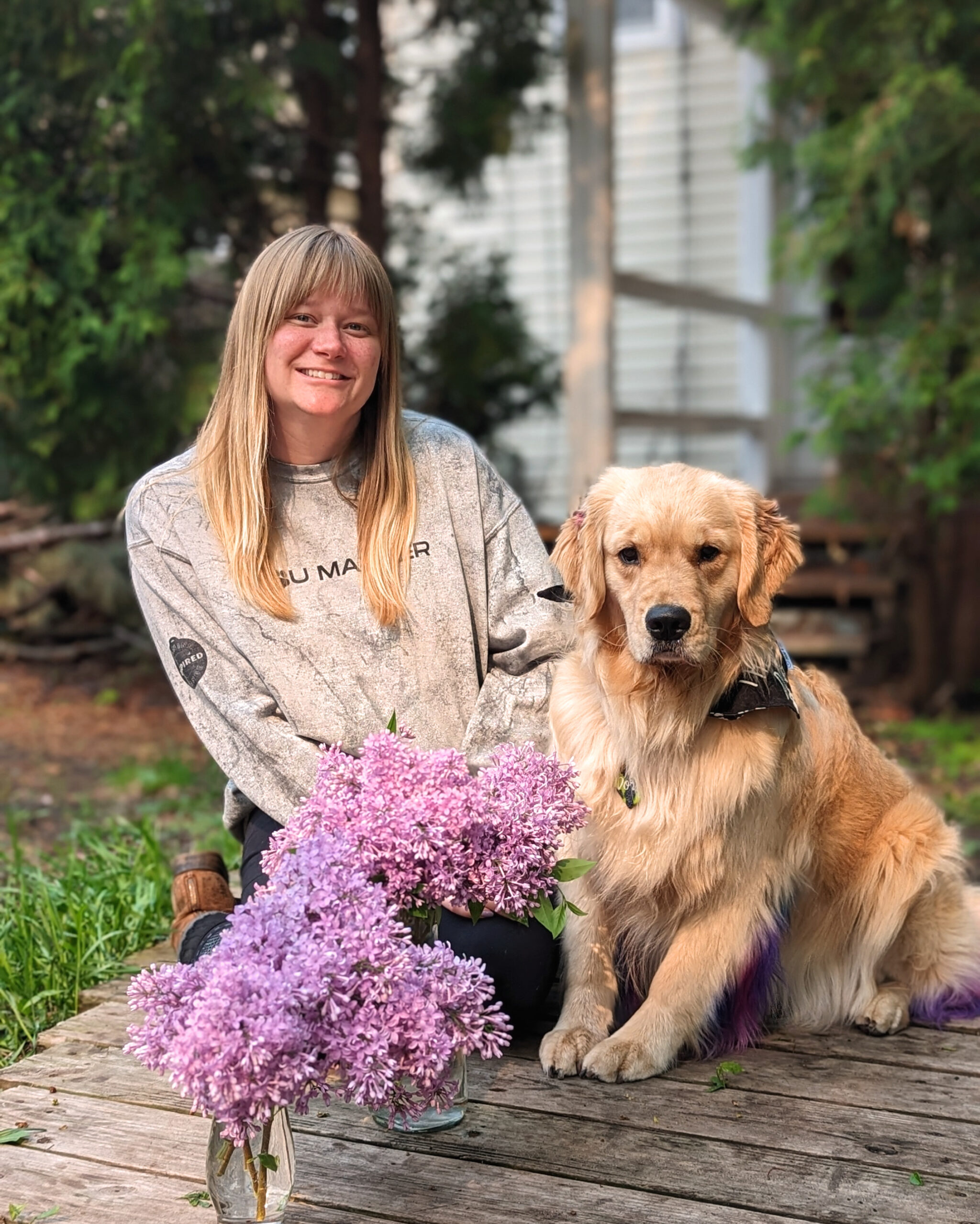 Metro Dogs trainer, Taylor with her Golden Retriever Dory and fresh cut lilacs.